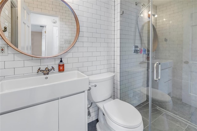 full bath with toilet, tasteful backsplash, tile walls, a shower stall, and vanity