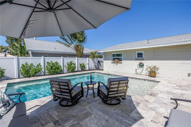 view of swimming pool featuring a fenced backyard, a fenced in pool, and a patio