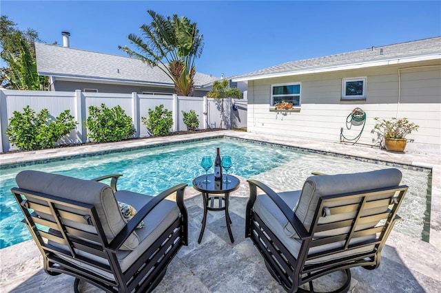 view of pool with a patio area, a fenced in pool, and a fenced backyard