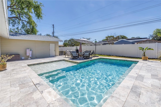 view of pool featuring a patio, a fenced backyard, and a fenced in pool