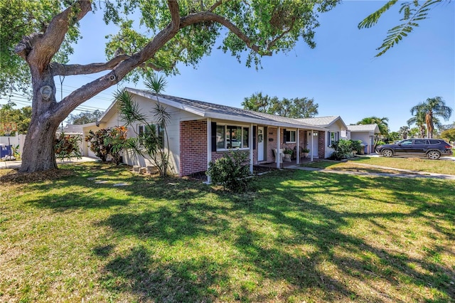 ranch-style house with brick siding and a front lawn