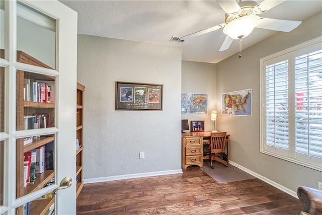 office featuring baseboards, wood finished floors, a textured wall, a textured ceiling, and a ceiling fan