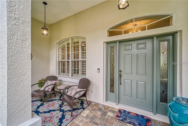 property entrance featuring stucco siding and a porch