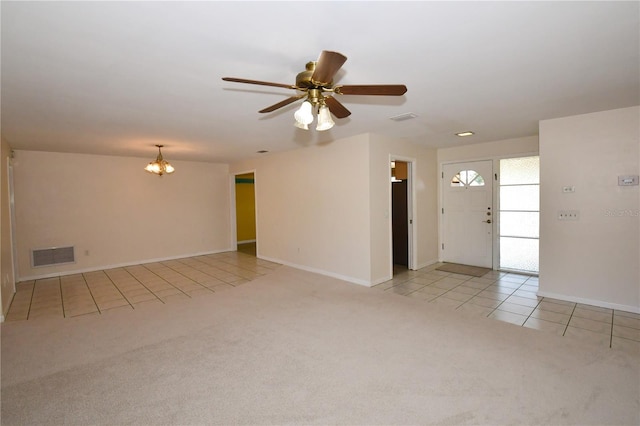 unfurnished living room with baseboards, visible vents, light tile patterned flooring, light carpet, and ceiling fan with notable chandelier