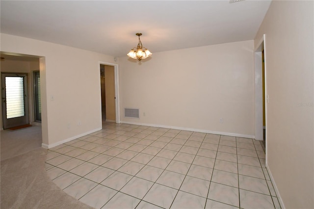 unfurnished room featuring visible vents, baseboards, and a chandelier