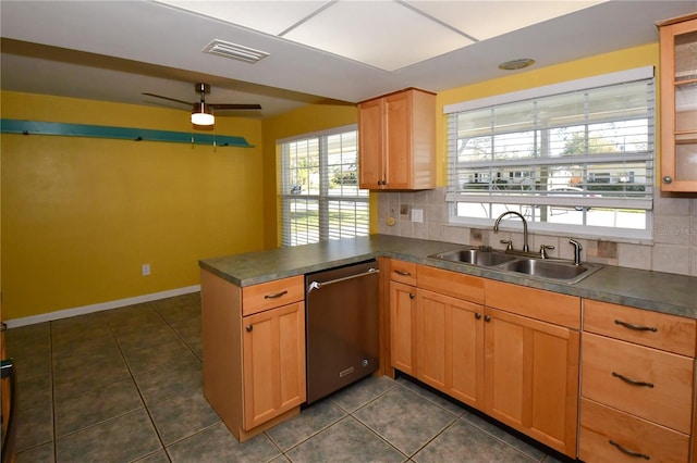 kitchen featuring visible vents, a sink, backsplash, dark countertops, and dishwasher