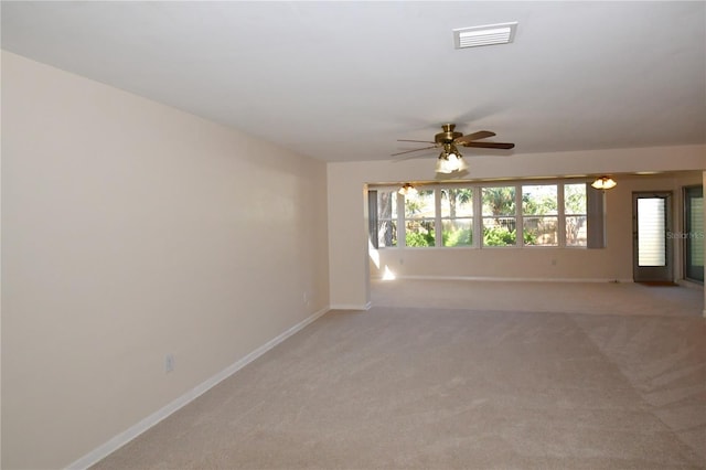 unfurnished room with plenty of natural light, baseboards, visible vents, and ceiling fan