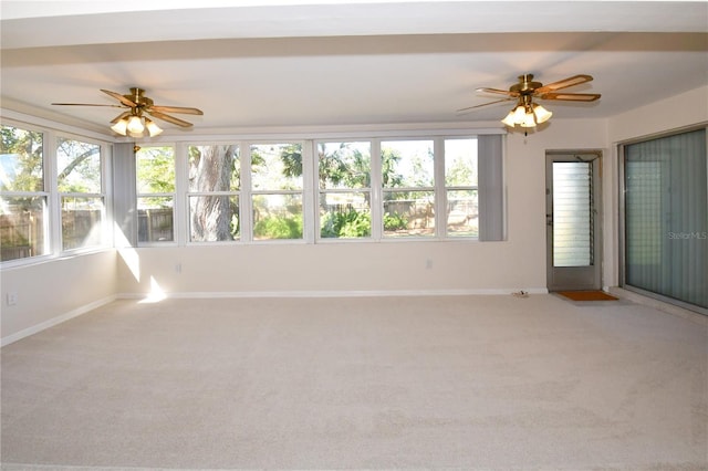 unfurnished sunroom with a healthy amount of sunlight and ceiling fan