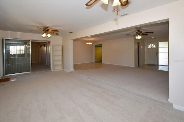 unfurnished living room with carpet flooring, a ceiling fan, and visible vents