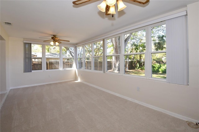 unfurnished sunroom with visible vents and ceiling fan