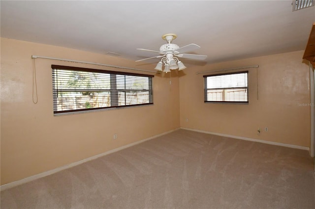 unfurnished room with visible vents, baseboards, ceiling fan, and carpet flooring