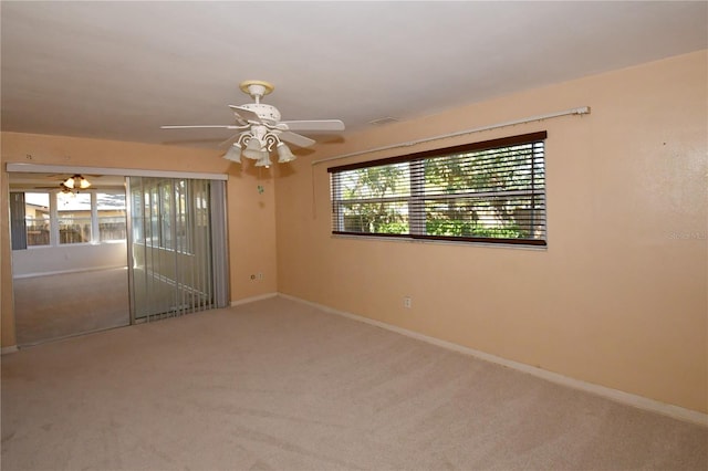 empty room featuring visible vents, baseboards, carpet, and ceiling fan