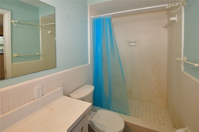 full bathroom featuring wainscoting, a shower stall, tile walls, and toilet