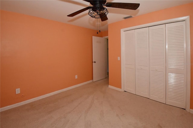 unfurnished bedroom with visible vents, a ceiling fan, a closet, baseboards, and light colored carpet