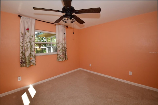 spare room featuring baseboards, carpet floors, and ceiling fan