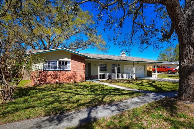 ranch-style home with brick siding, a front lawn, covered porch, driveway, and an attached garage