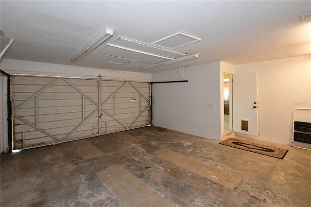 garage featuring visible vents and heating unit