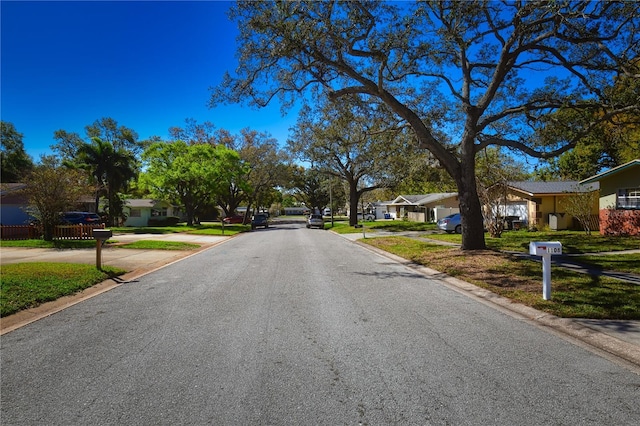 view of street featuring sidewalks, a residential view, and curbs