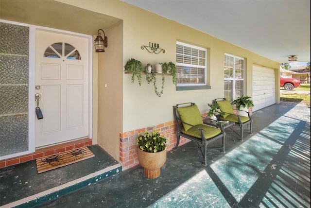 entrance to property with stucco siding and brick siding