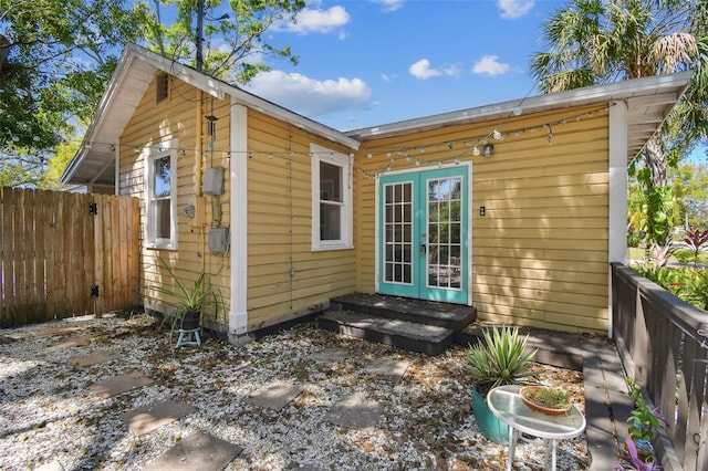 back of house with french doors and fence