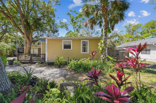 rear view of house with a deck and fence