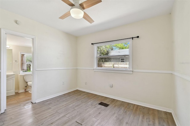 empty room with wood finished floors, baseboards, and ceiling fan