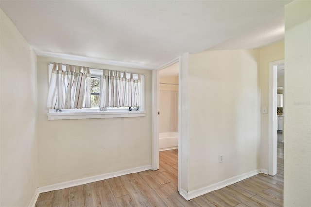 spare room with wood finished floors and baseboards