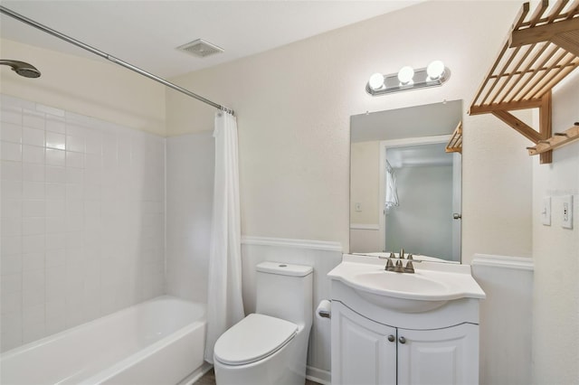 full bath with vanity, shower / tub combo, toilet, and visible vents