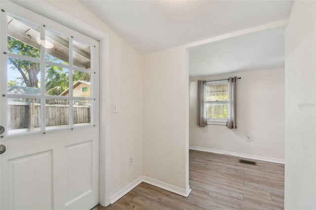 entryway featuring wood finished floors, visible vents, and baseboards