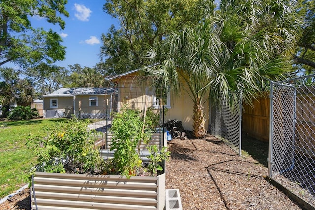 view of yard with a vegetable garden and fence