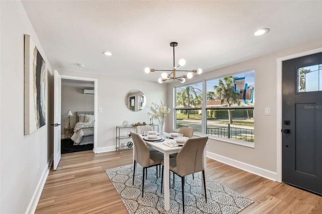 dining area featuring a healthy amount of sunlight, light wood-style flooring, and baseboards