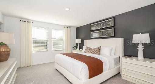 carpeted bedroom featuring baseboards