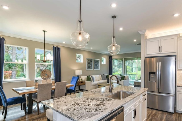 kitchen featuring ornamental molding, a sink, white cabinetry, stainless steel appliances, and dark wood-style flooring