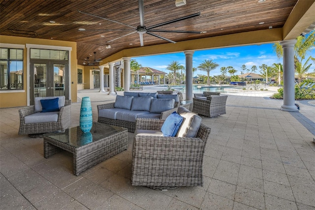 view of patio / terrace with an outdoor pool, an outdoor living space, and french doors