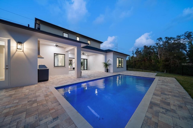 view of pool featuring a fenced in pool, fence, a ceiling fan, and a patio area