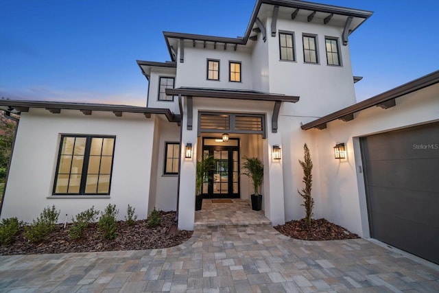 view of exterior entry featuring stucco siding