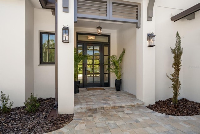 property entrance with french doors and stucco siding