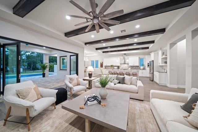 living area featuring visible vents, beamed ceiling, recessed lighting, light wood finished floors, and ceiling fan