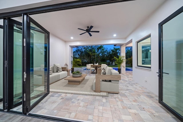 view of patio / terrace with outdoor dining area, an outdoor hangout area, and a ceiling fan