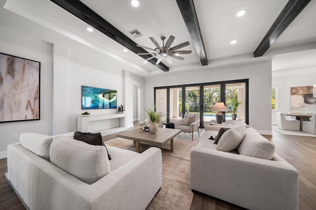 living area with recessed lighting, baseboards, and beam ceiling