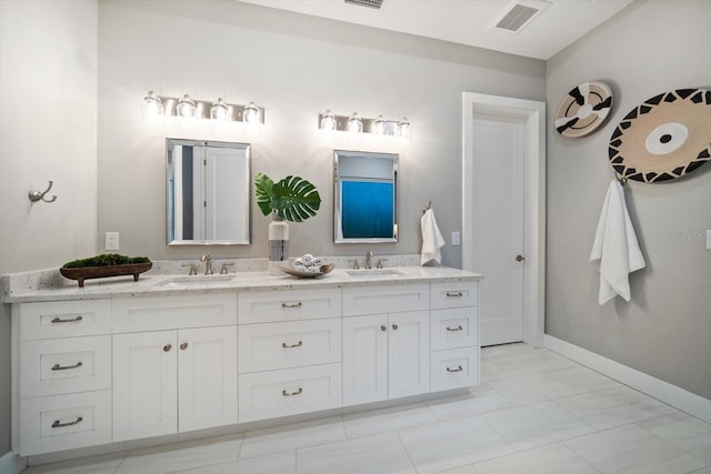 full bathroom featuring a sink, visible vents, baseboards, and double vanity