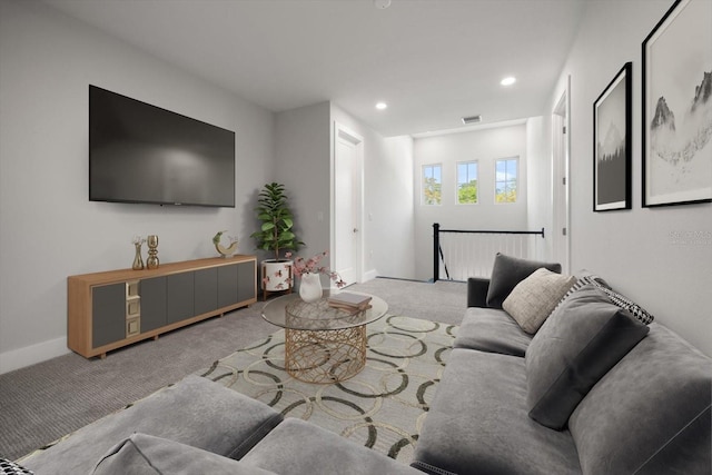 living room with recessed lighting, visible vents, baseboards, and carpet