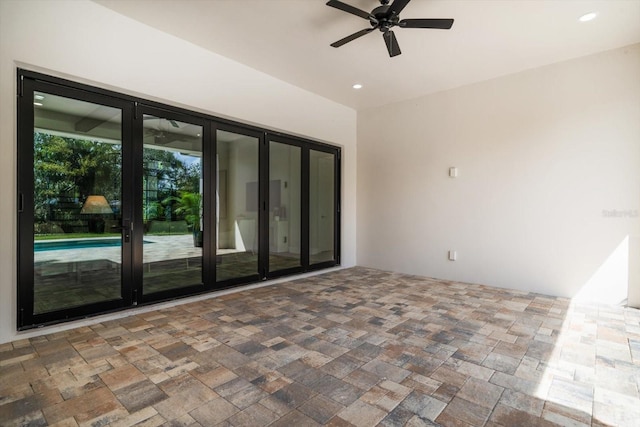 empty room featuring recessed lighting, a ceiling fan, and stone finish flooring