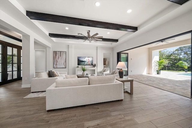 living area with beam ceiling, recessed lighting, ceiling fan, and wood finished floors