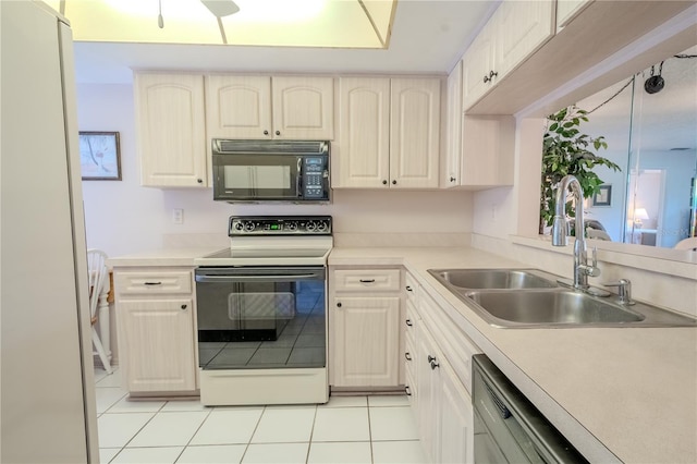 kitchen with a sink, white appliances, light tile patterned flooring, and light countertops