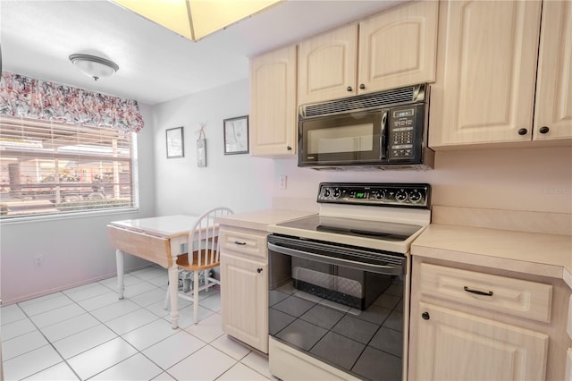 kitchen with light countertops, light brown cabinets, black microwave, and electric range oven