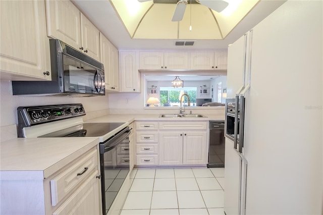 kitchen with visible vents, light tile patterned flooring, a sink, black appliances, and light countertops