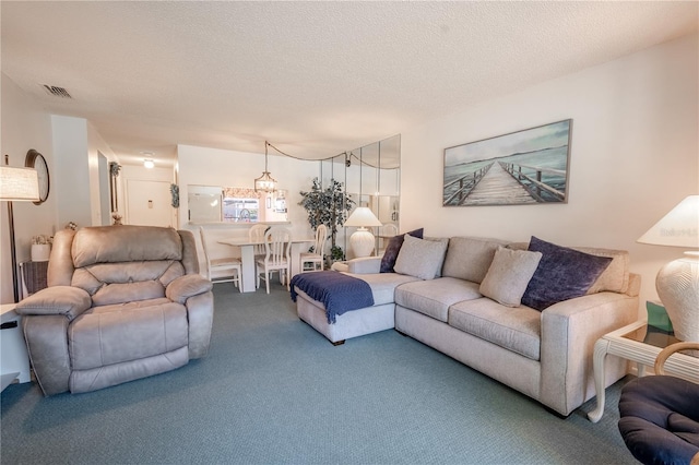 carpeted living room with visible vents and a textured ceiling