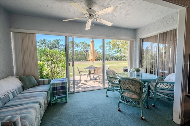 sunroom featuring a ceiling fan