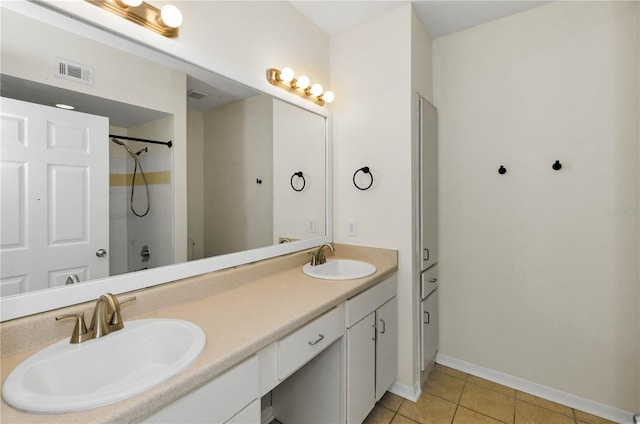 bathroom featuring tile patterned floors, a sink, double vanity, and visible vents